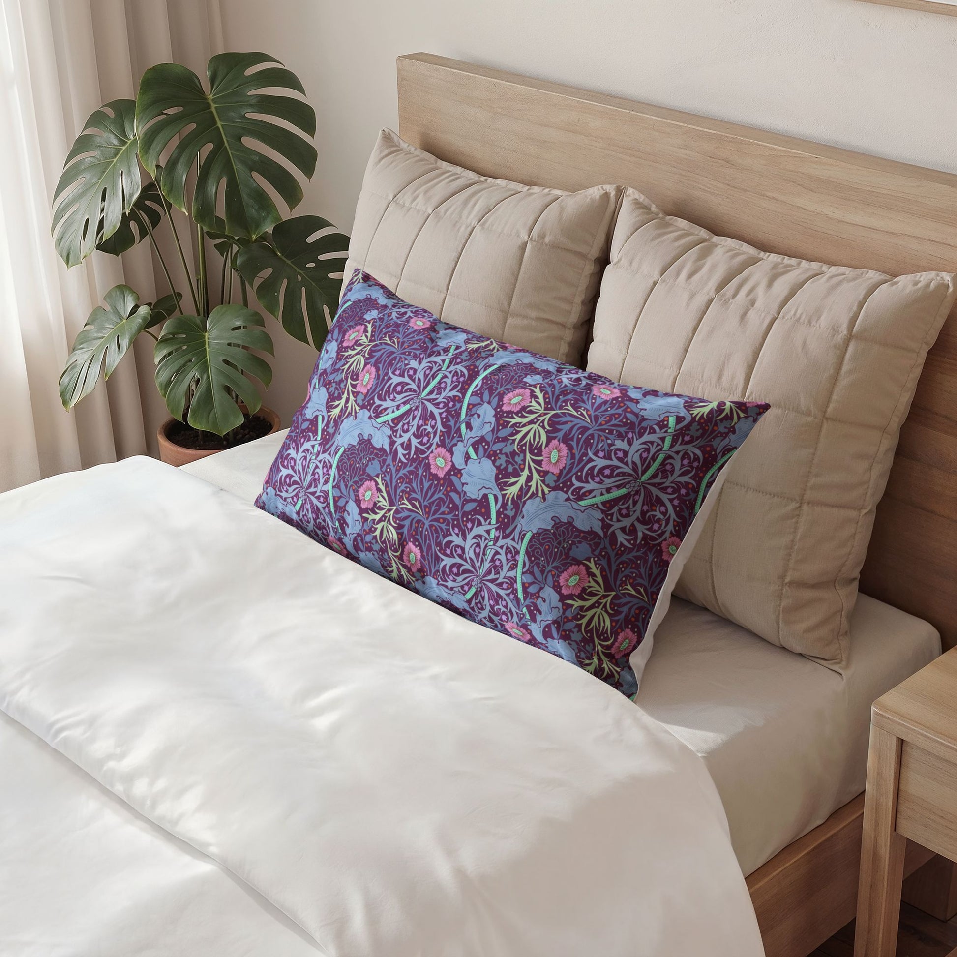 Decorative pillow with floral pattern on a bed in a bedroom setting