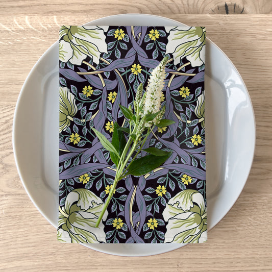 A floral patterned cotton twill napkin inspired by William Morris, displayed on a plate with a white flower decoration.