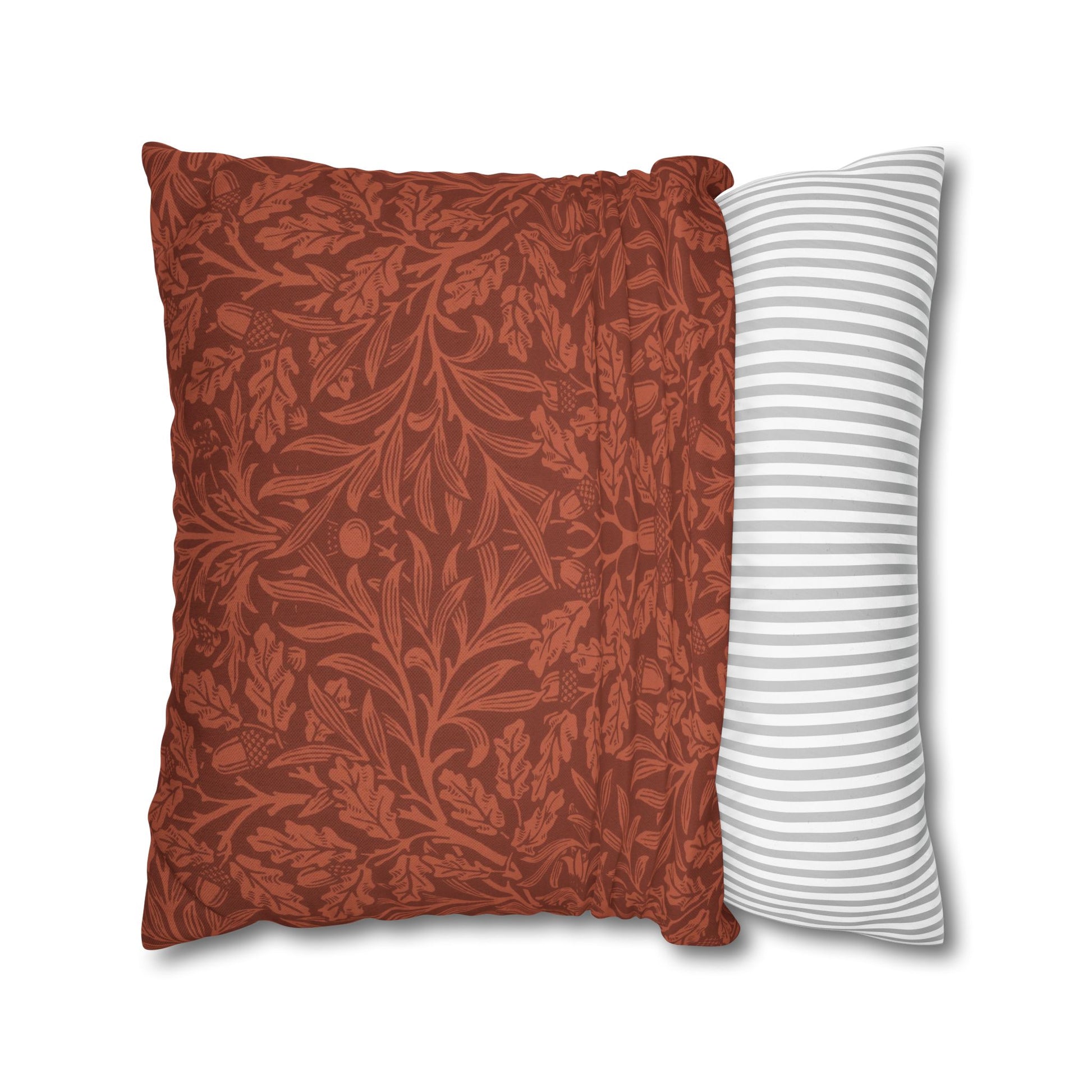 Two pillows, one with a red floral pattern and the other with white stripes, on a white background.
