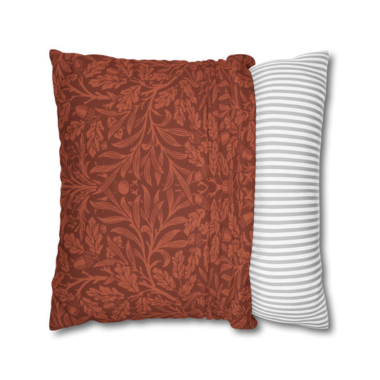 Two pillows, one with a red floral pattern and the other with white stripes, on a white background.
