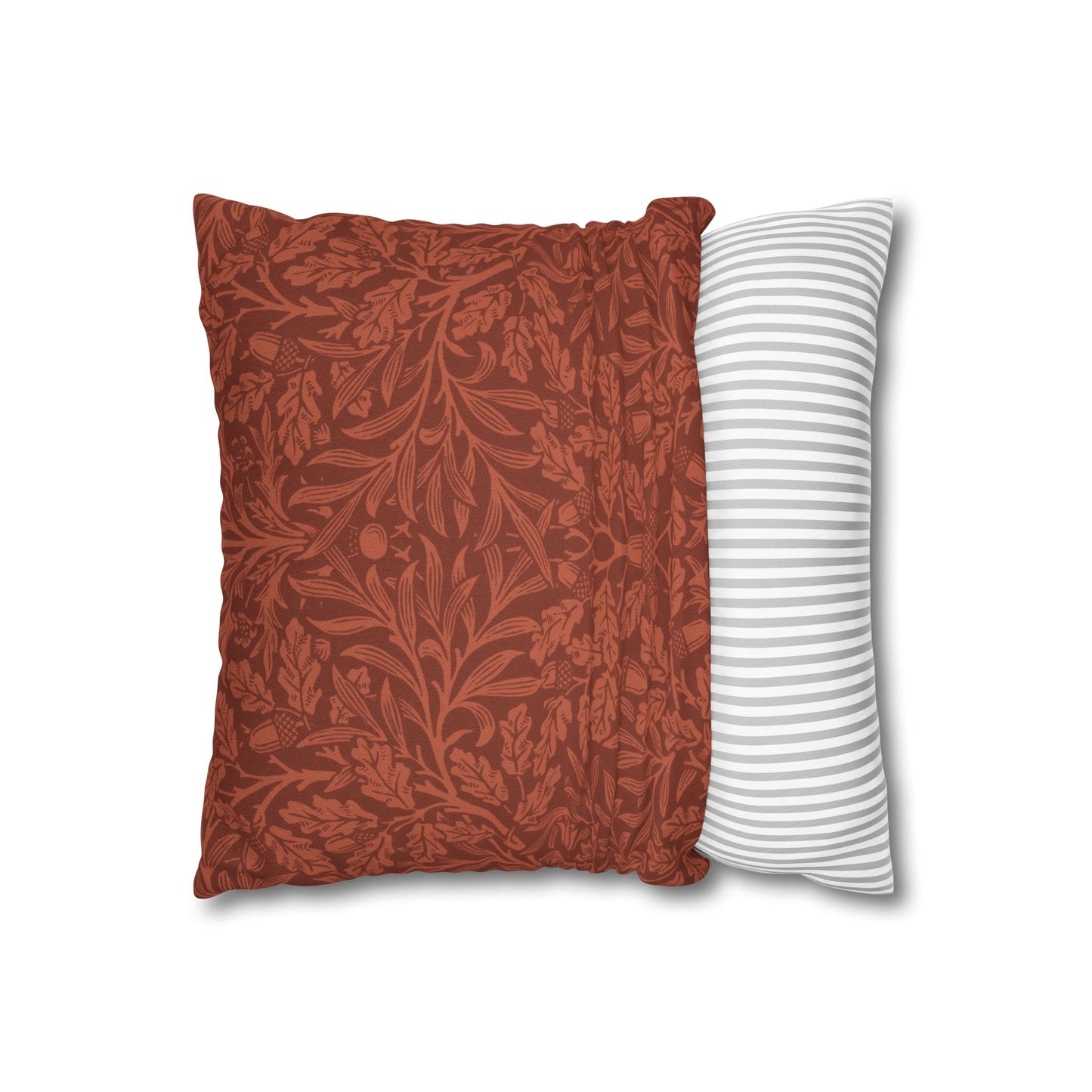 Two pillows, one with a red floral pattern and the other with white stripes, on a white background.