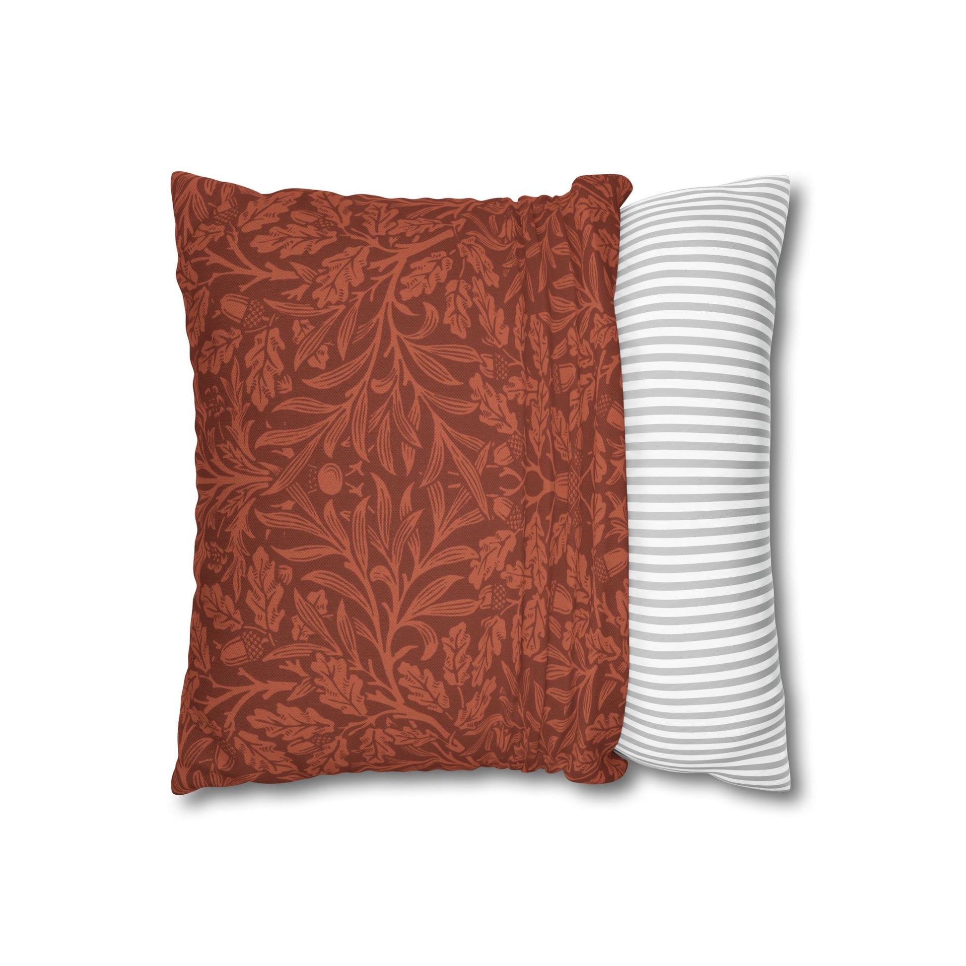 Two pillows, one with a red floral pattern and the other with white stripes, on a white background.