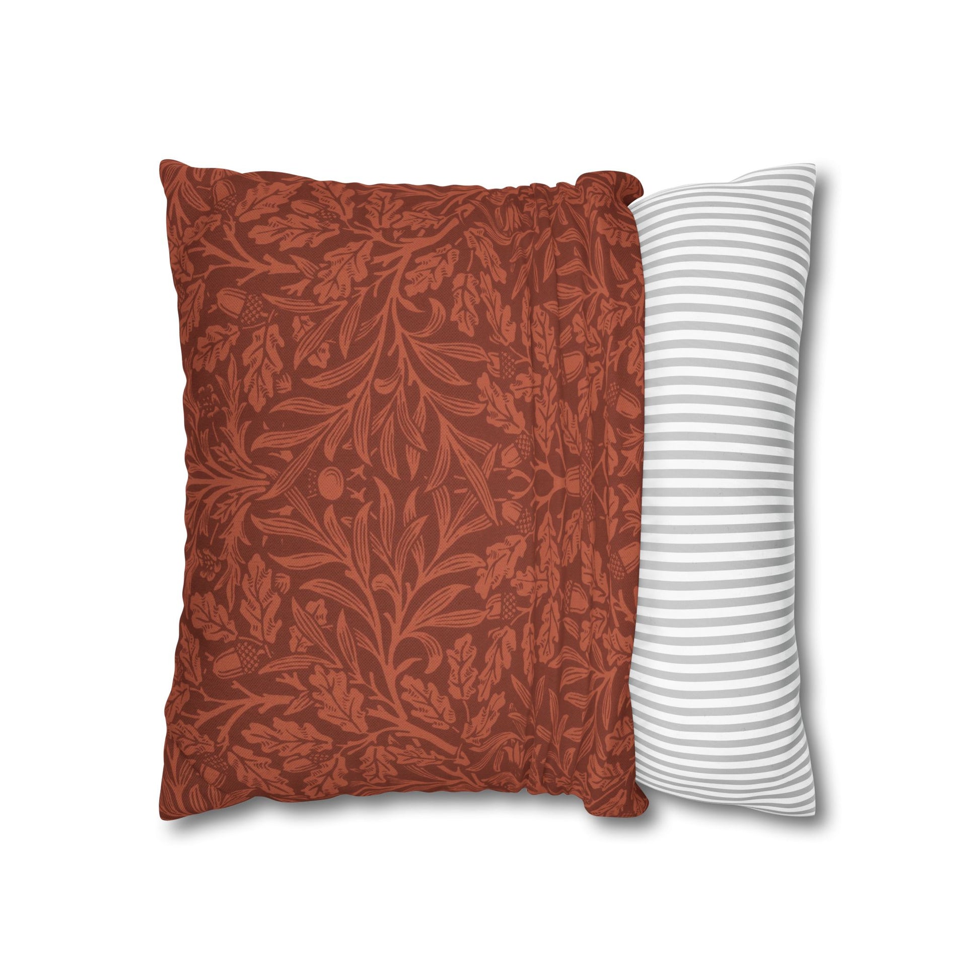 Two pillows, one with a red floral pattern and the other with white stripes, on a white background.