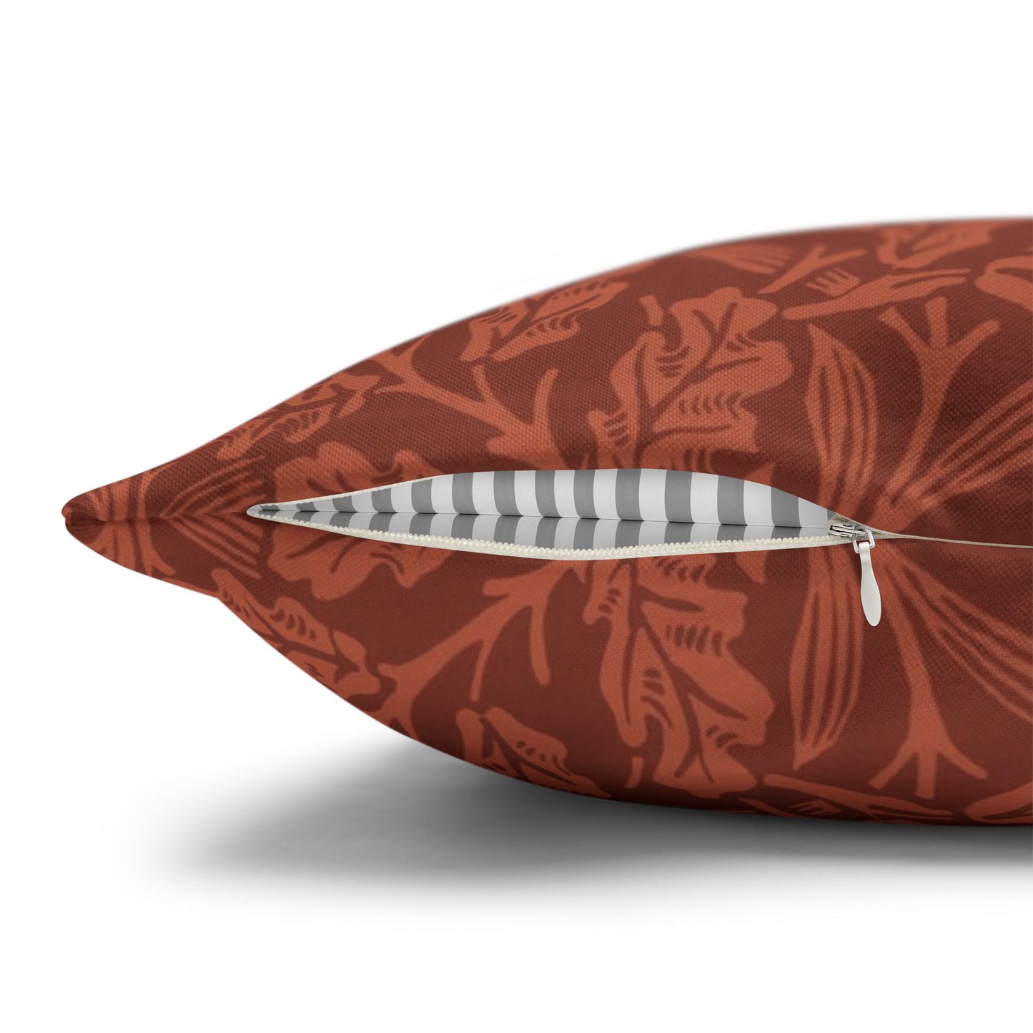 Decorative pillow with floral pattern and zipper on a white background