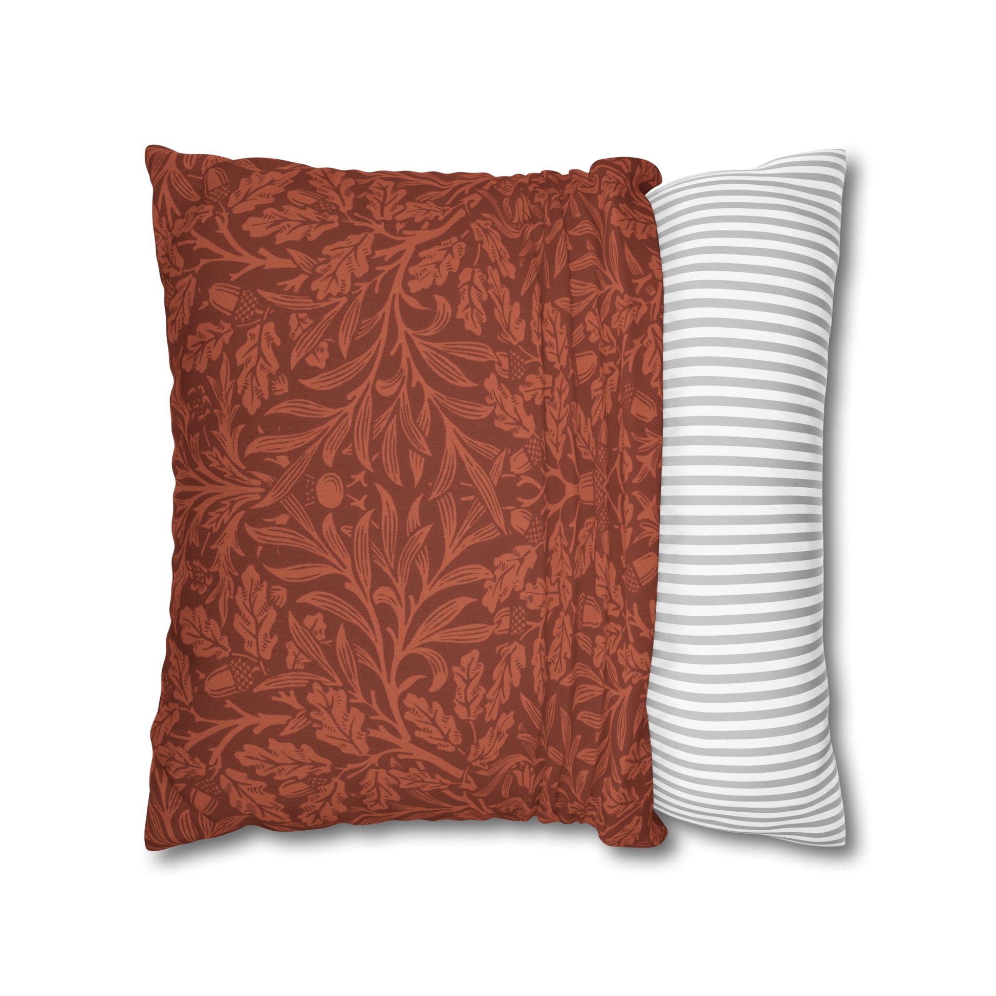 Two pillows, one with a red leaf pattern and the other with a white and gray striped pattern, on a white background.