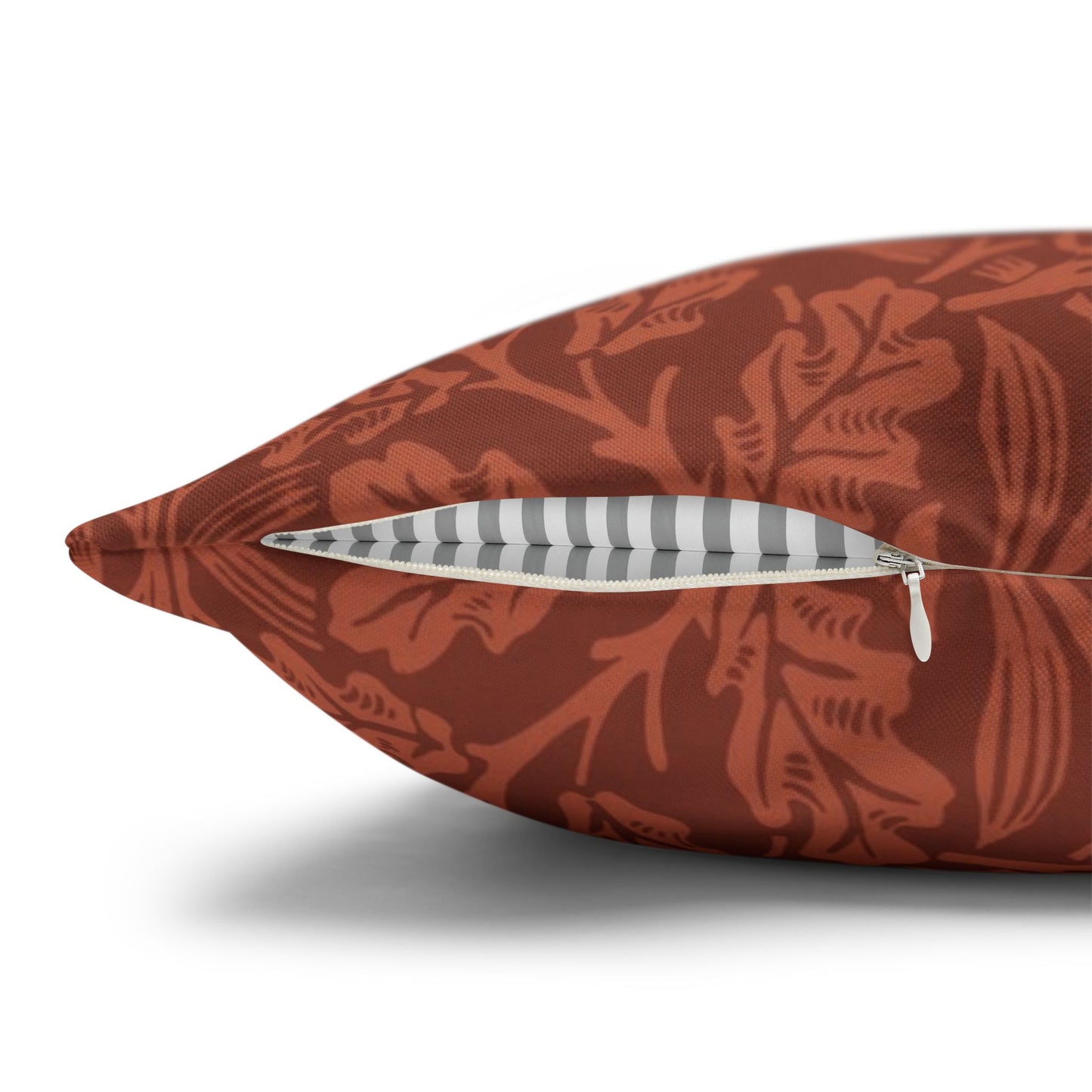 Decorative pillow with a red leaf pattern on a white background