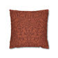 Decorative pillow with a red leaf pattern on a white background