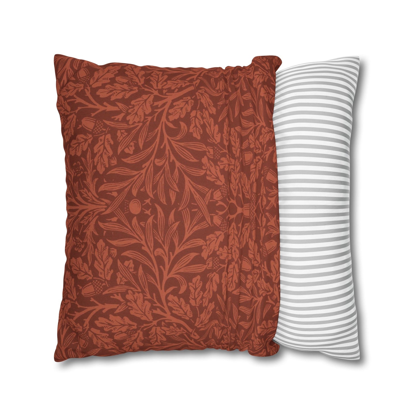 Two pillows, one with a red floral pattern and the other with white stripes, on a white background.