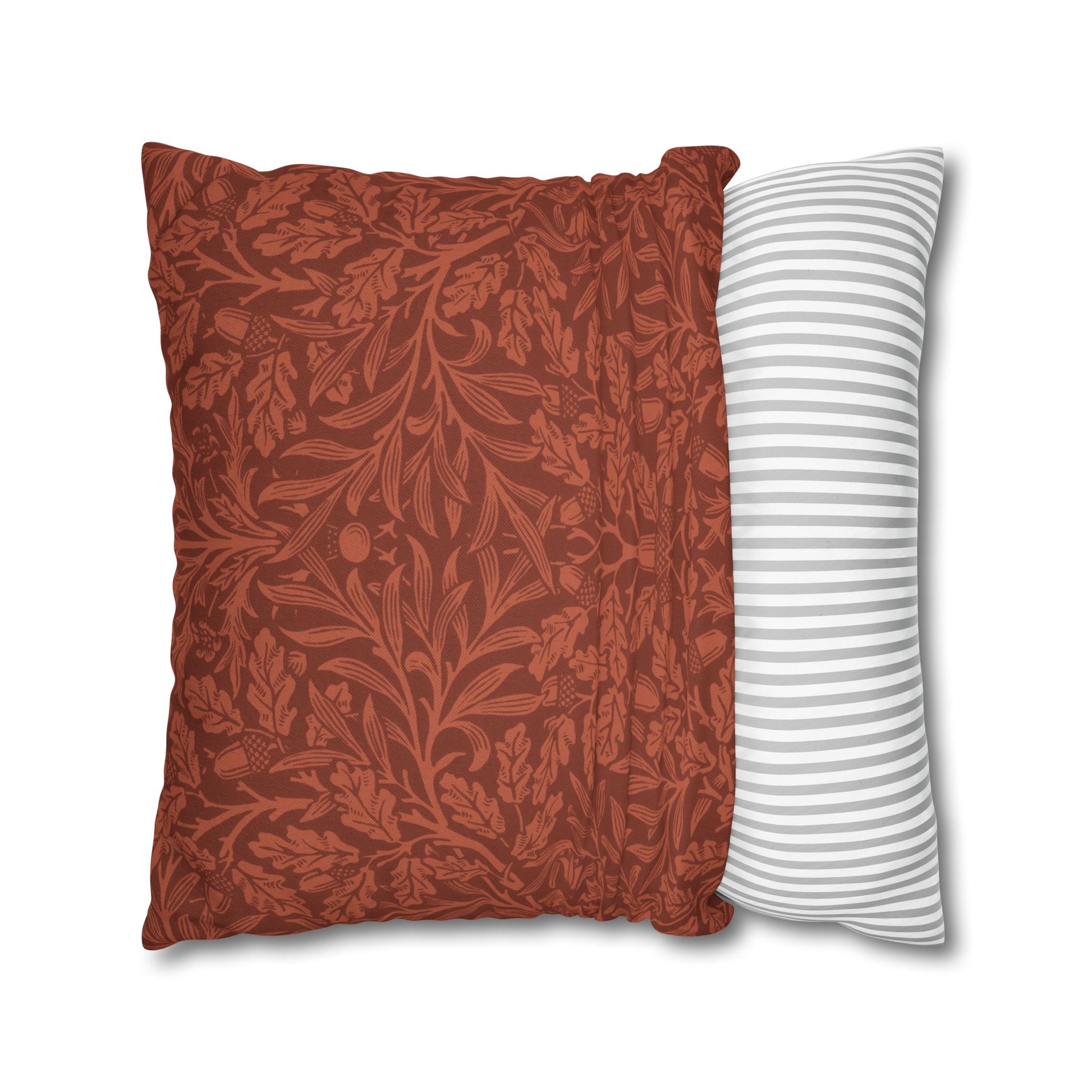 Two pillows, one with a red floral pattern and the other with white stripes, on a white background.
