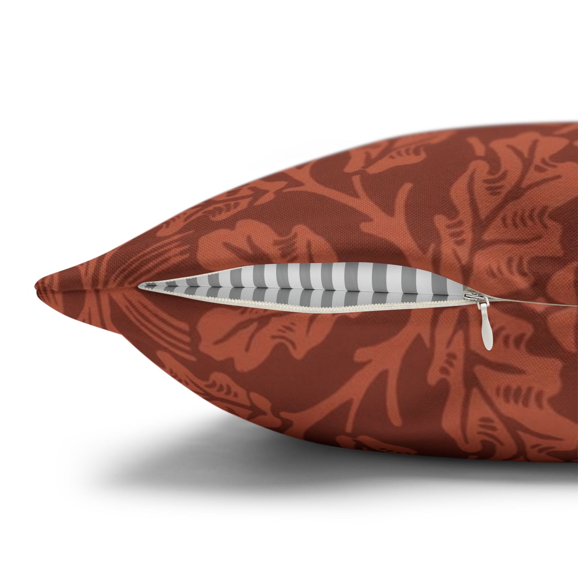 Decorative pillow with a floral pattern and a zipper on a white background