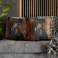 Decorative pillows with religious-themed design on a gray sofa.