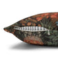 Decorative pillow with a floral pattern and a feather on a white background