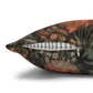Decorative pillow with a floral and bird pattern on a white background