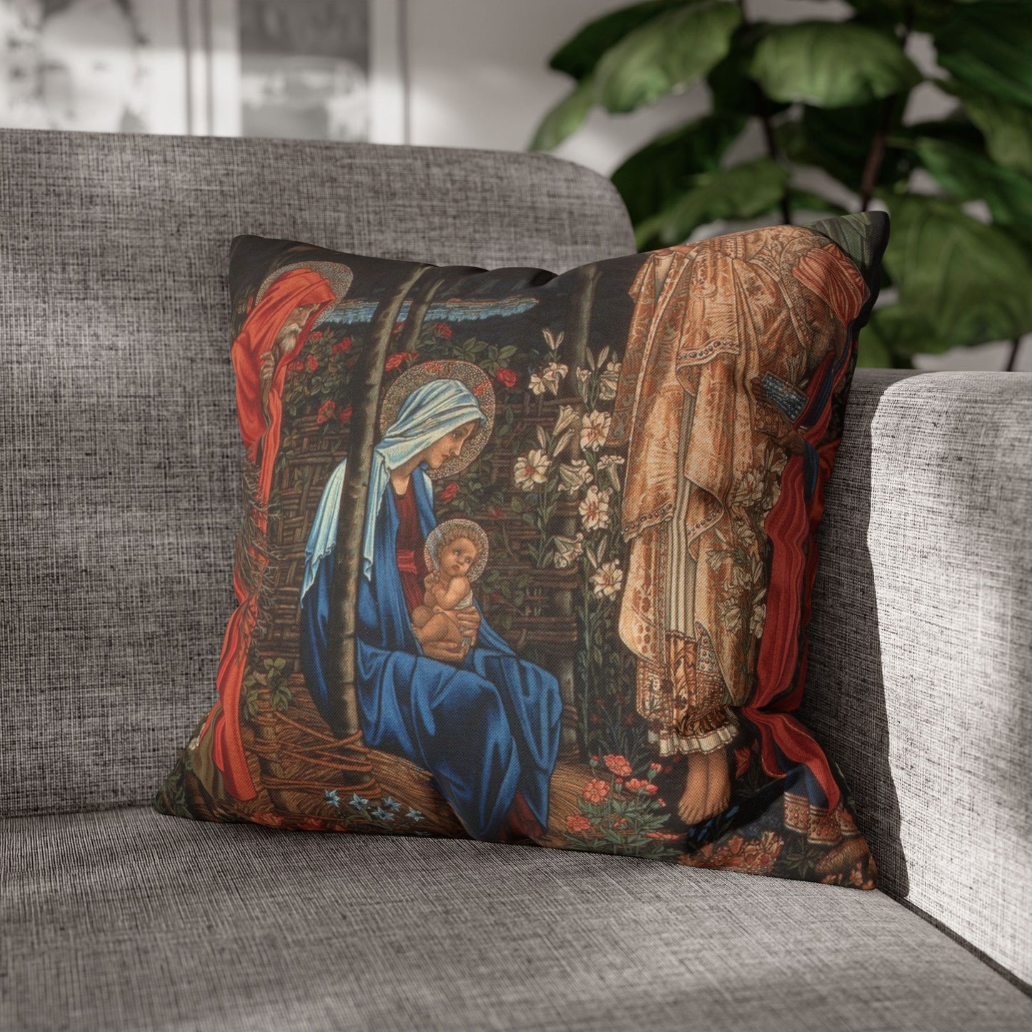 Decorative pillow with religious design on a gray couch