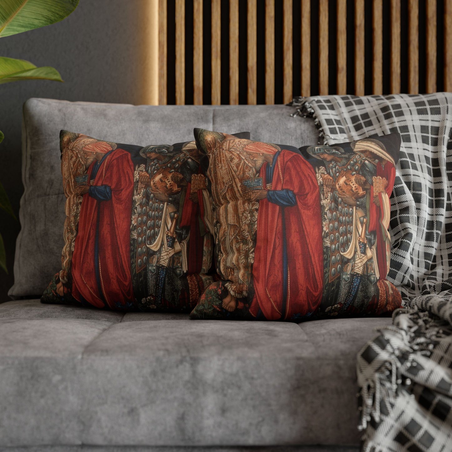 Decorative pillows with intricate designs on a gray sofa against a wooden panel wall.