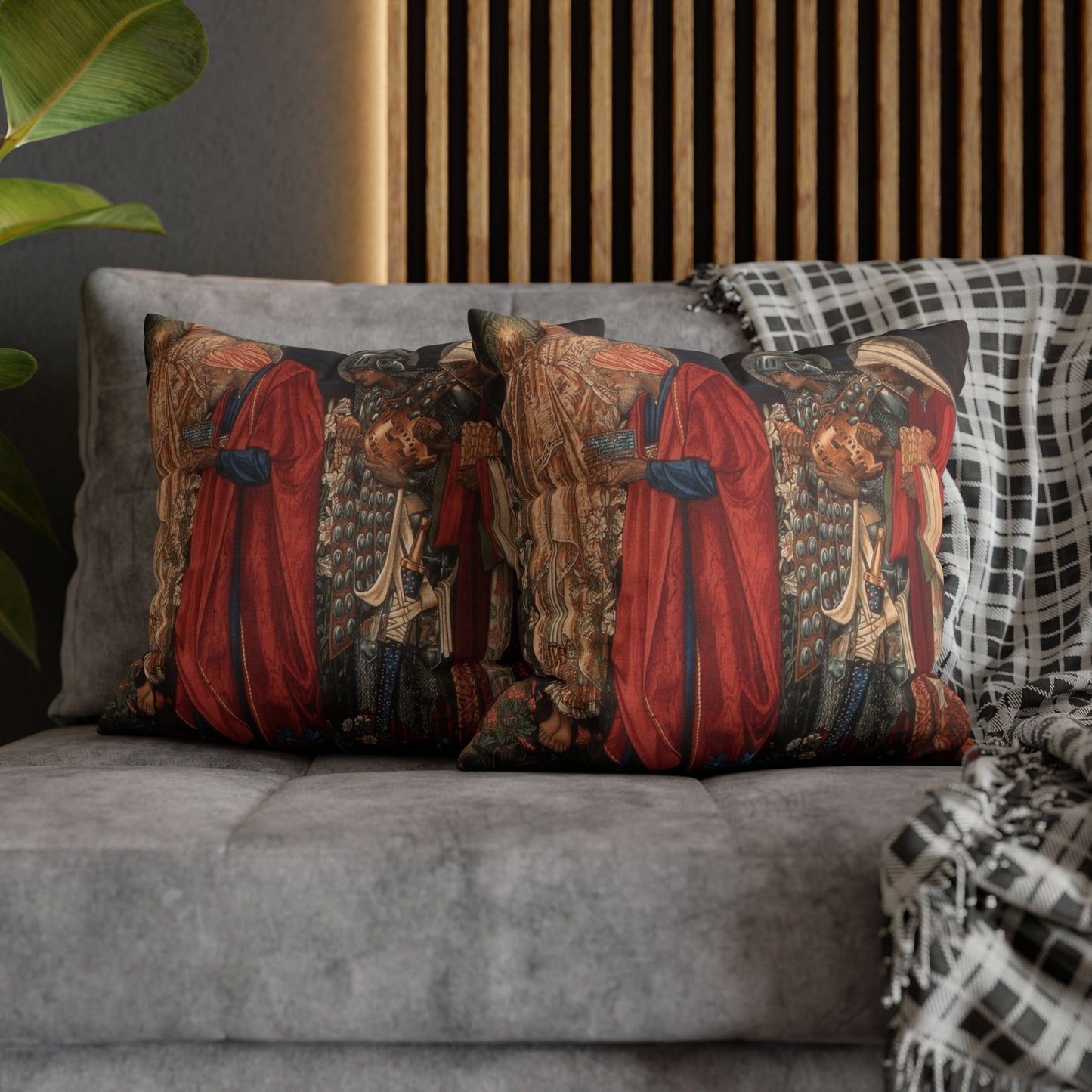 Decorative pillows with intricate designs on a gray sofa against a wooden panel wall.