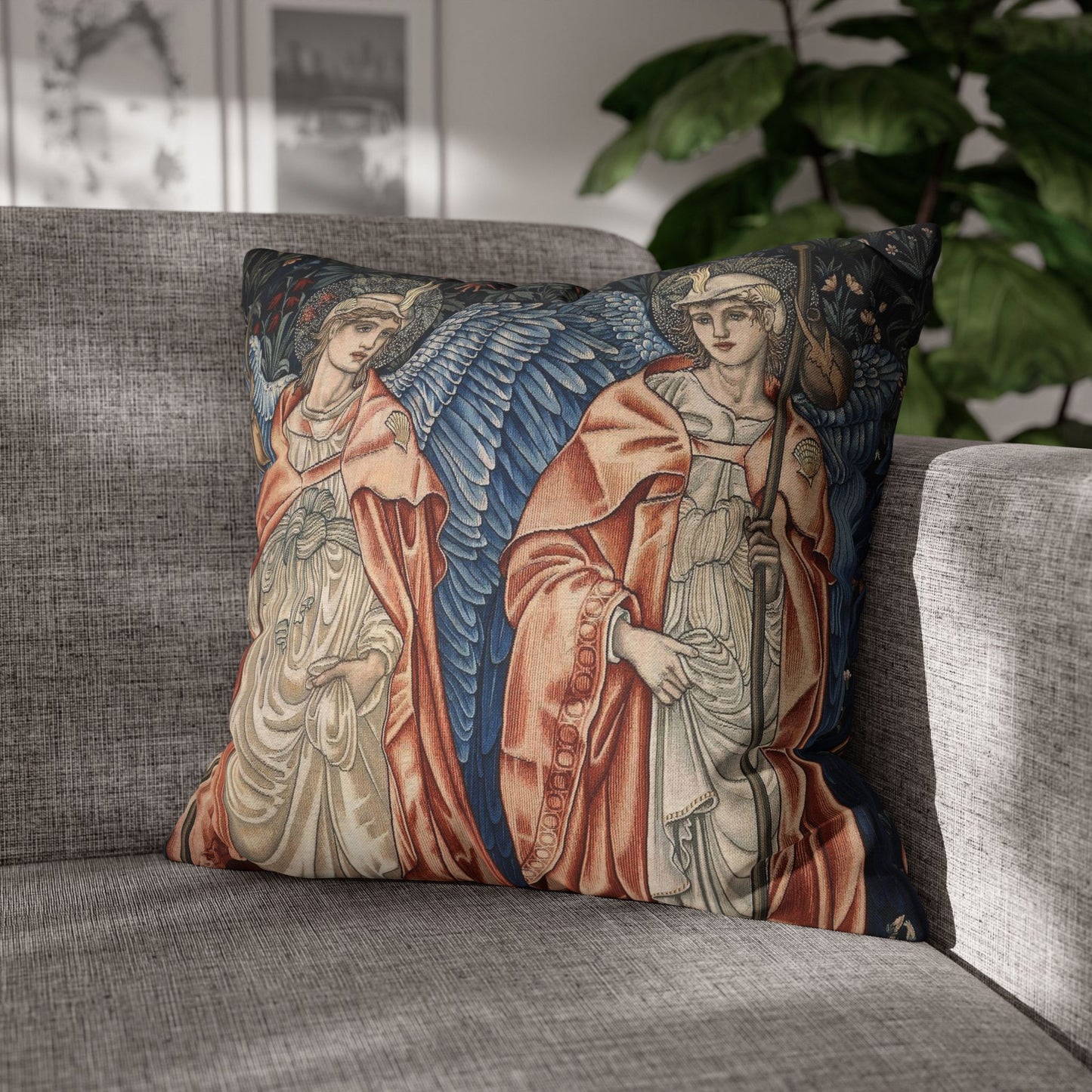Decorative pillow with angel design on a gray sofa
