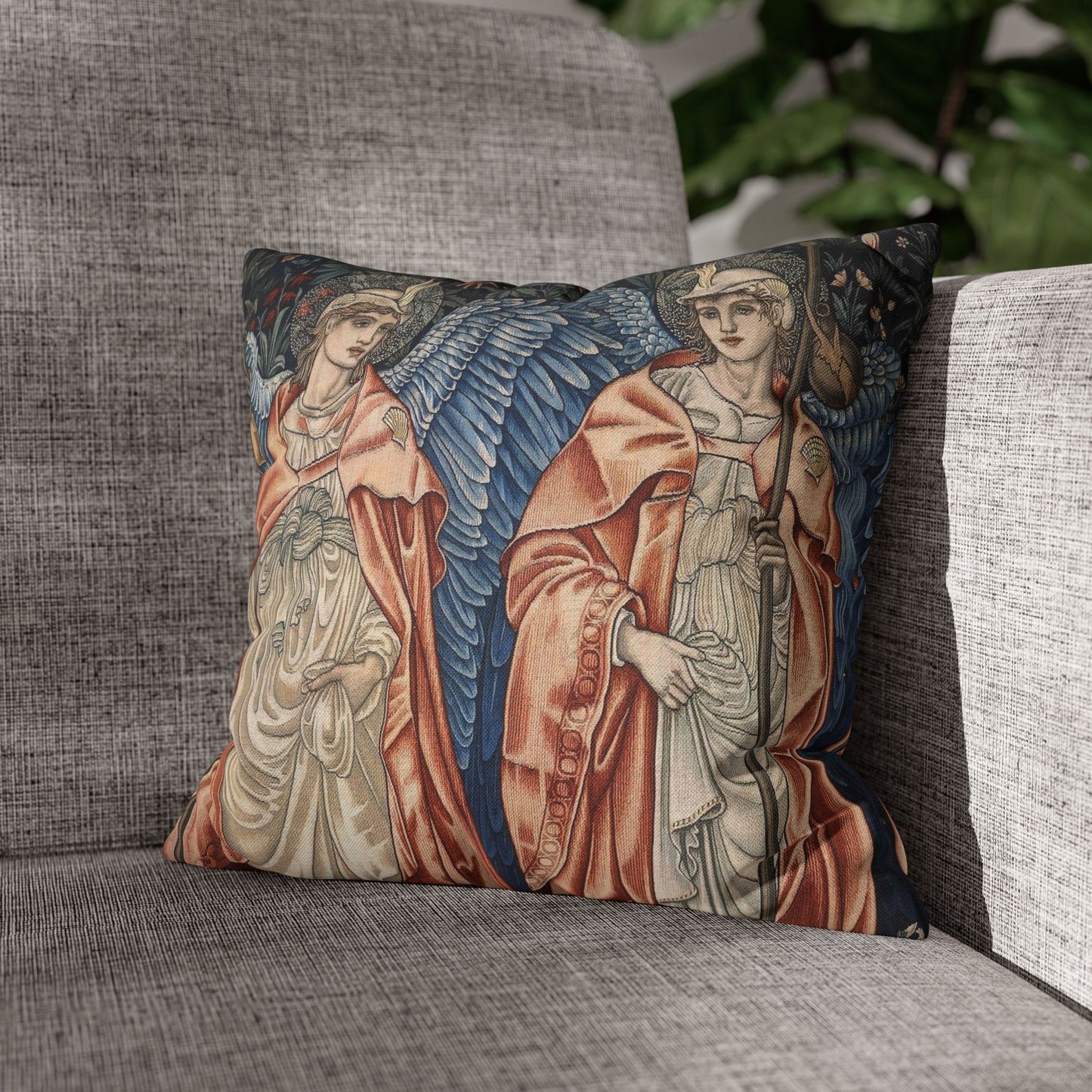 Decorative pillow with angel design on a gray sofa