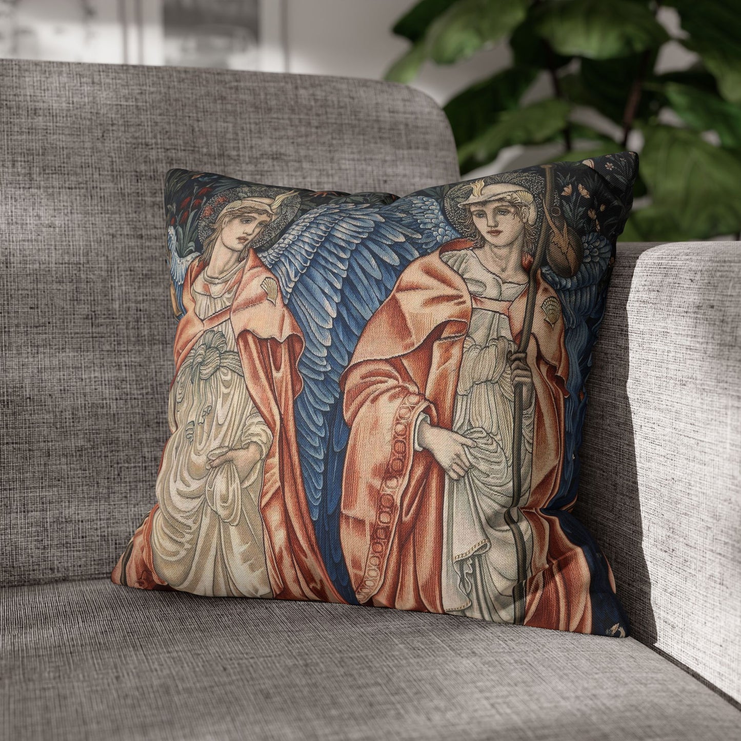 Decorative pillow with angel design on a gray sofa