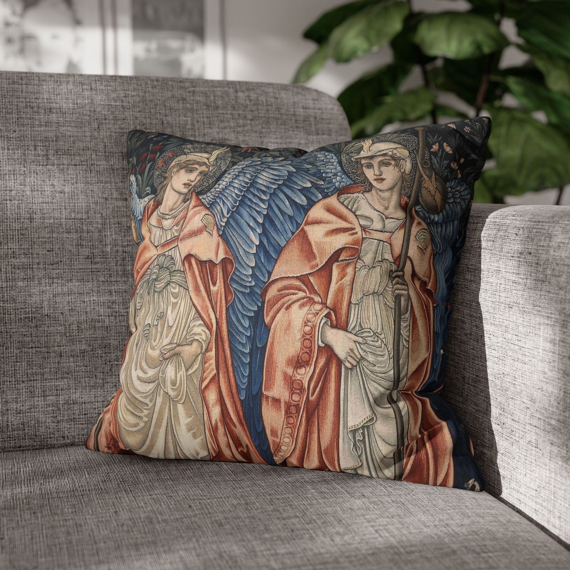 Decorative pillow with angel design on a gray sofa