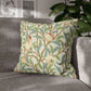 Decorative pillow with bird and floral pattern on a gray sofa