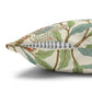 Decorative pillow with bird and leaf pattern on a white background