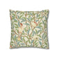 Decorative pillow with bird and leaf pattern on a white background