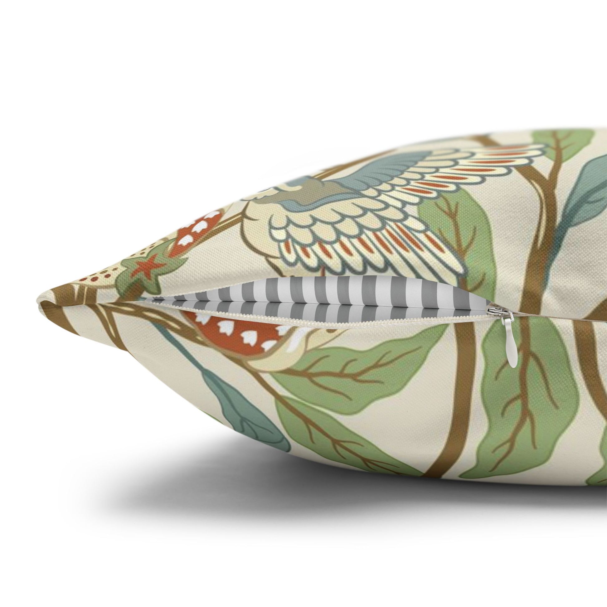 Decorative pillow with nature-themed pattern on a white background