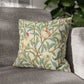 Decorative pillow with nature-themed pattern on a gray sofa