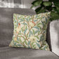 Decorative pillow with nature-themed design on a gray sofa