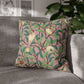 Decorative pillow with bird and leaf pattern on a gray sofa