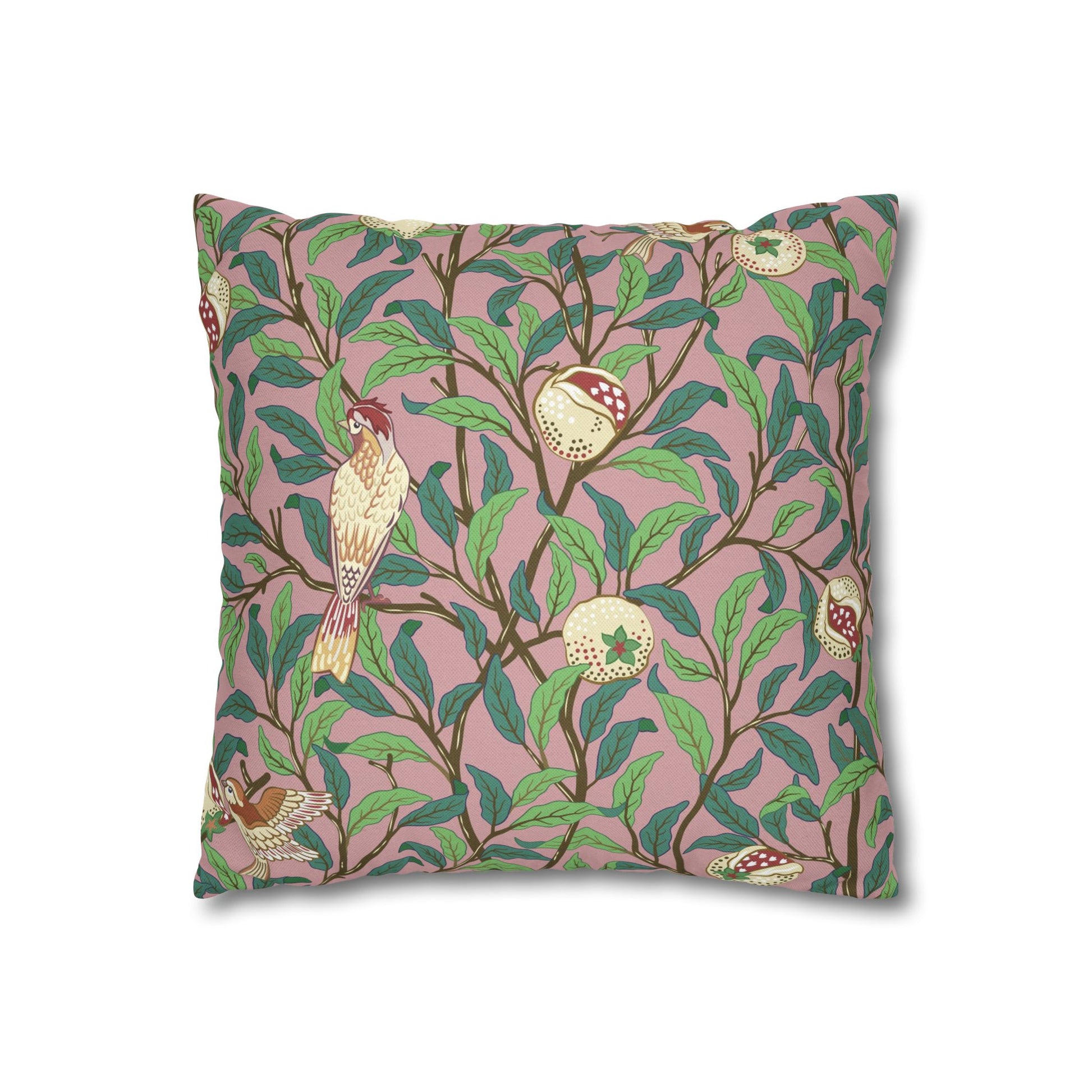 Decorative pillow with bird and leaf pattern on a pink background