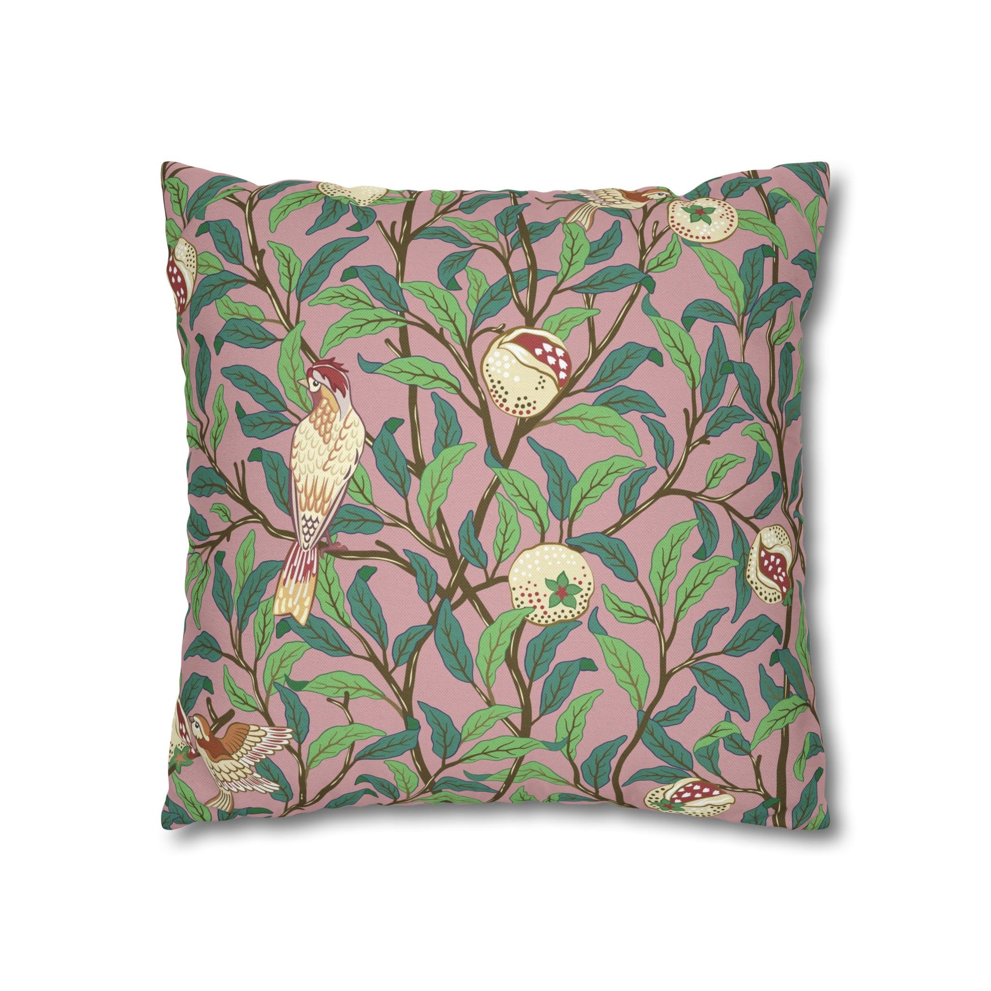 Decorative pillow with bird and leaf pattern on a pink background