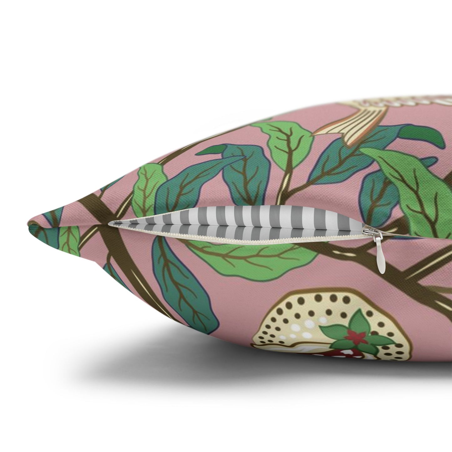 Decorative pillow with leaf pattern on a pink background