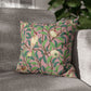 Decorative pillow with bird and pomegranate pattern on a gray sofa