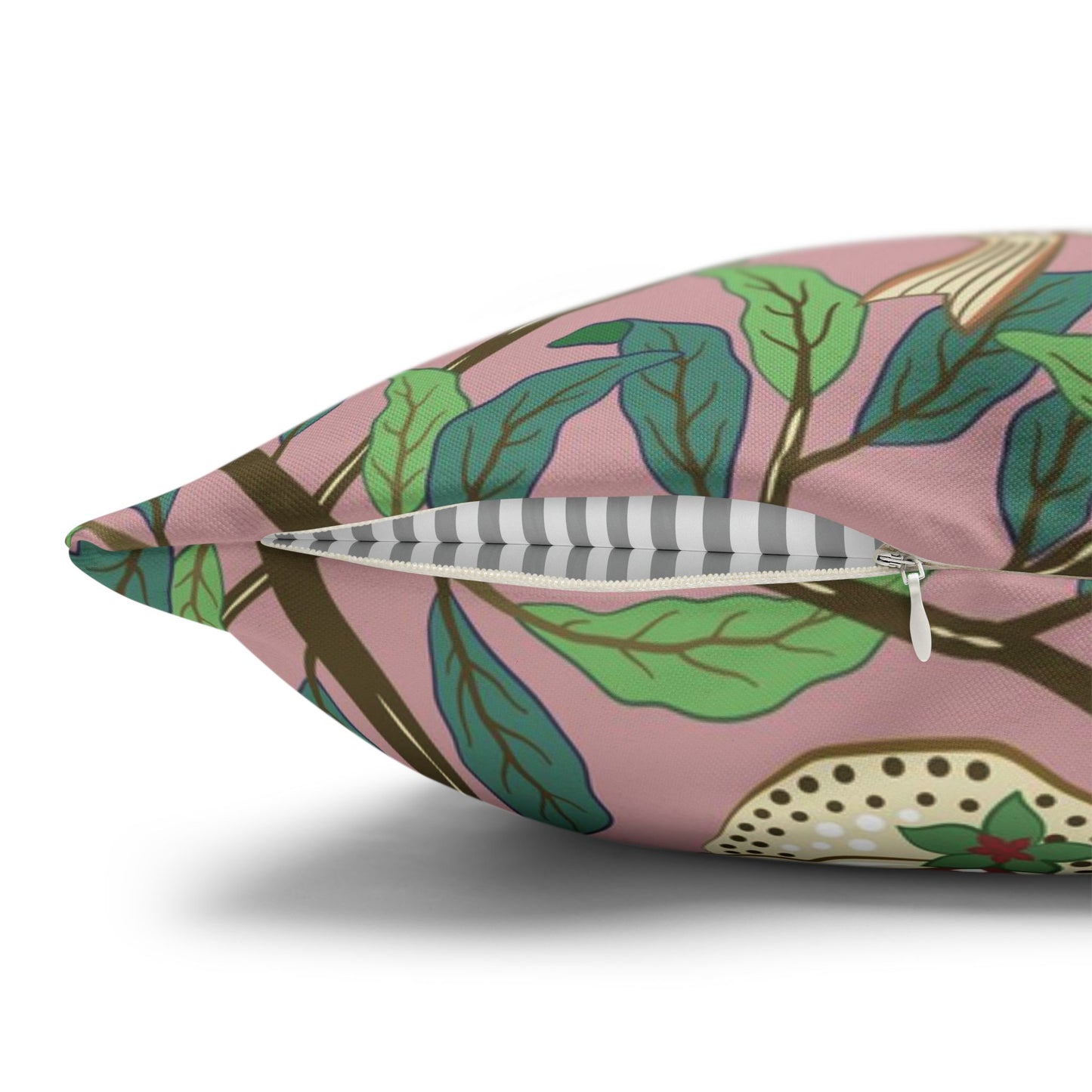 Decorative pillow with leaf pattern on a pink background