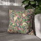 Decorative pillow with bird and leaf pattern on a gray sofa