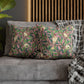 Decorative pillows with floral patterns on a gray sofa.