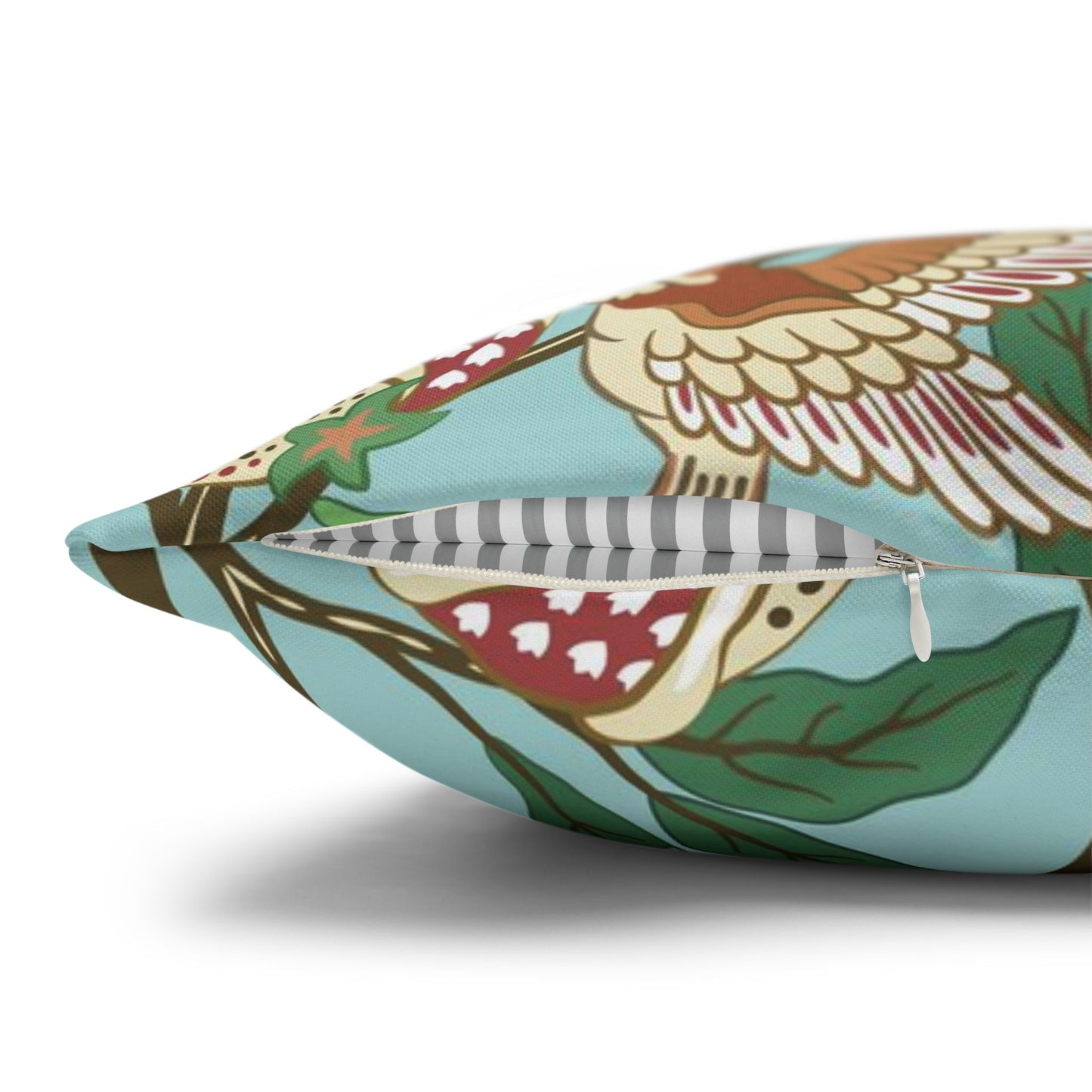 Decorative pillow with bird and floral pattern on a white background