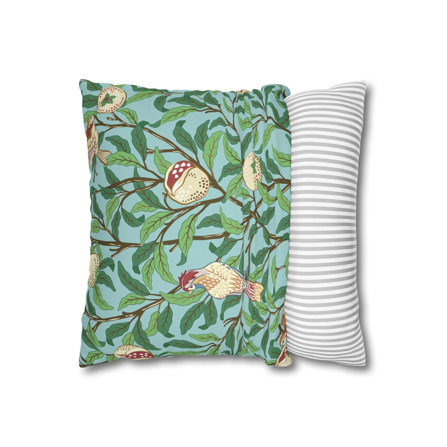 Decorative pillow with nature-themed design and a plain striped pillow next to it on a white background