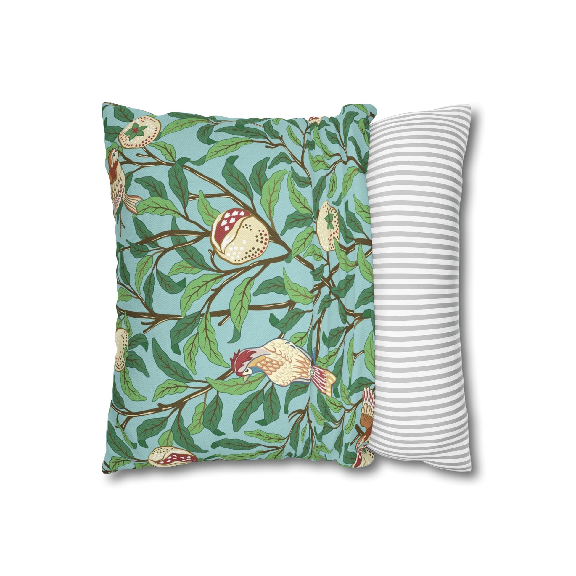 Decorative pillow with nature-themed design and striped pillow on a white background