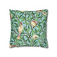Decorative pillow with bird and branch pattern on a blue background