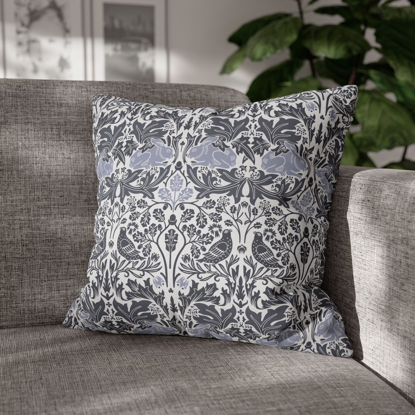 Decorative pillow with floral and bird pattern on a gray sofa