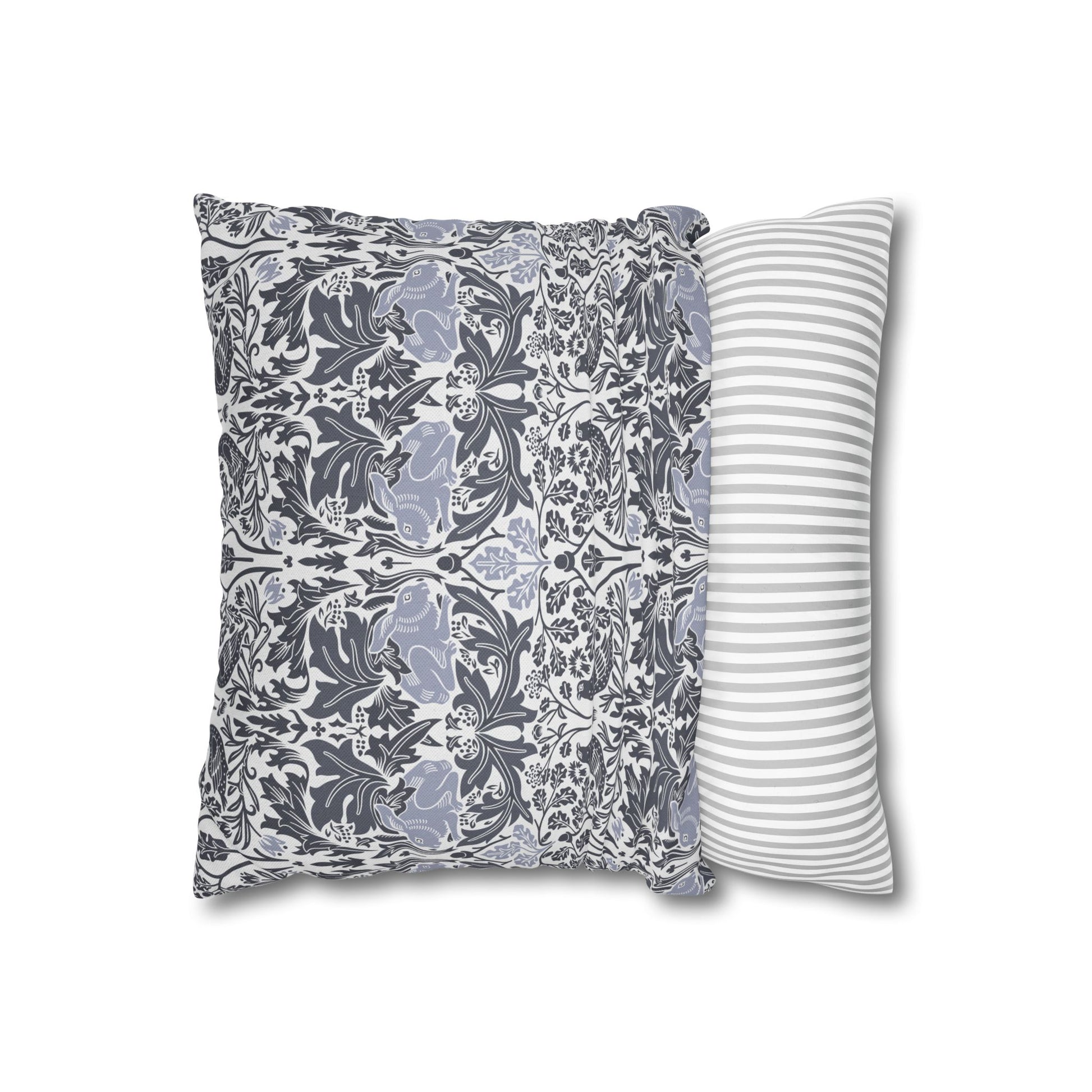 Two pillows, one with floral pattern and one with stripes, on a white background