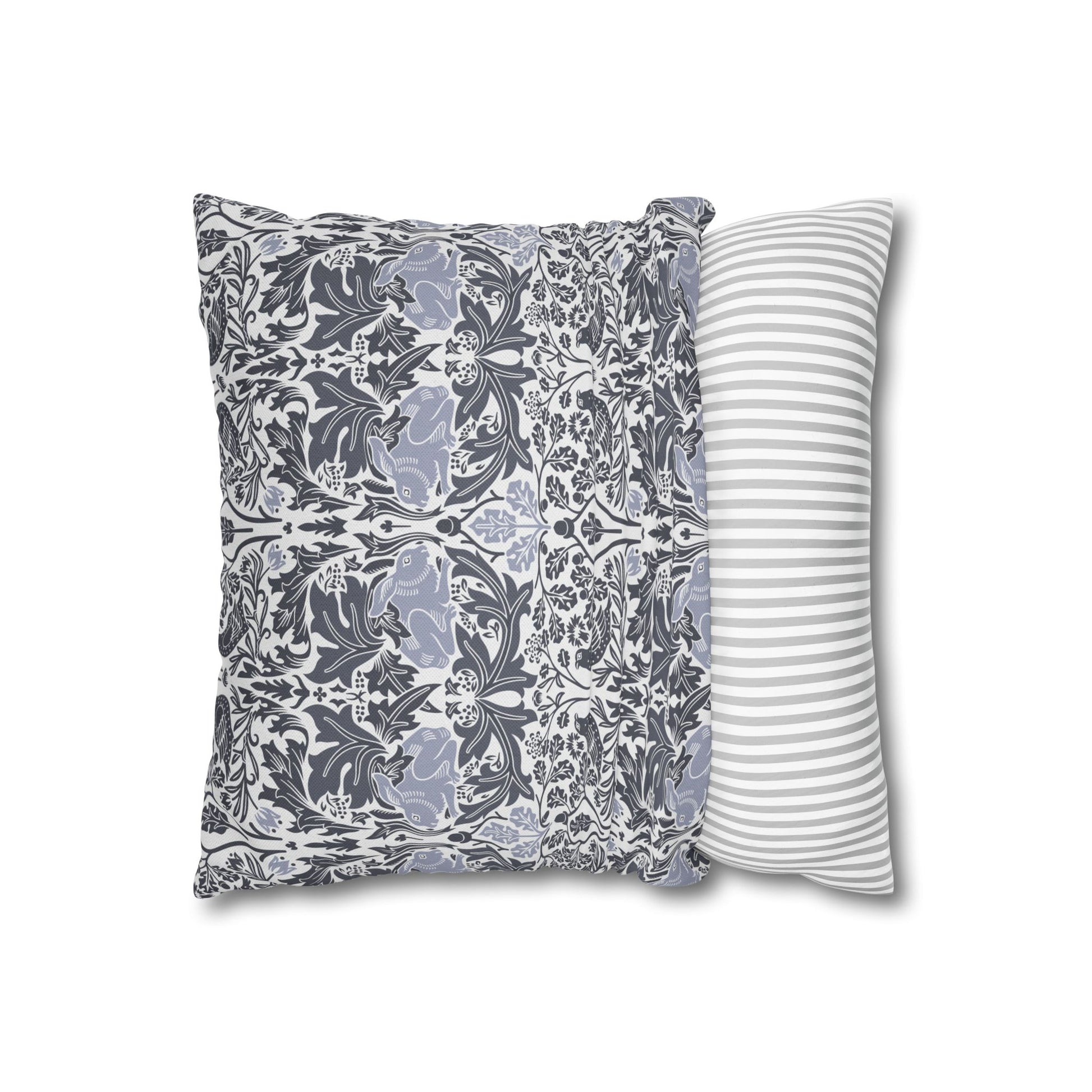 Two pillows, one with floral pattern and one with stripes, on a white background