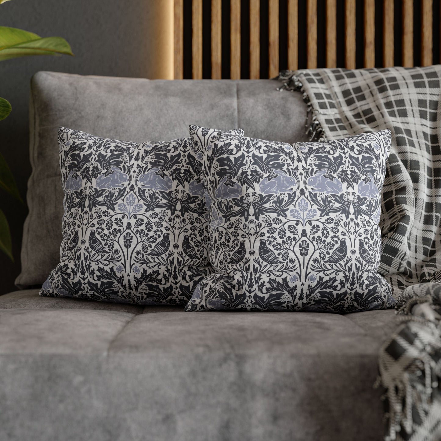 Decorative pillows with a floral pattern on a gray sofa.