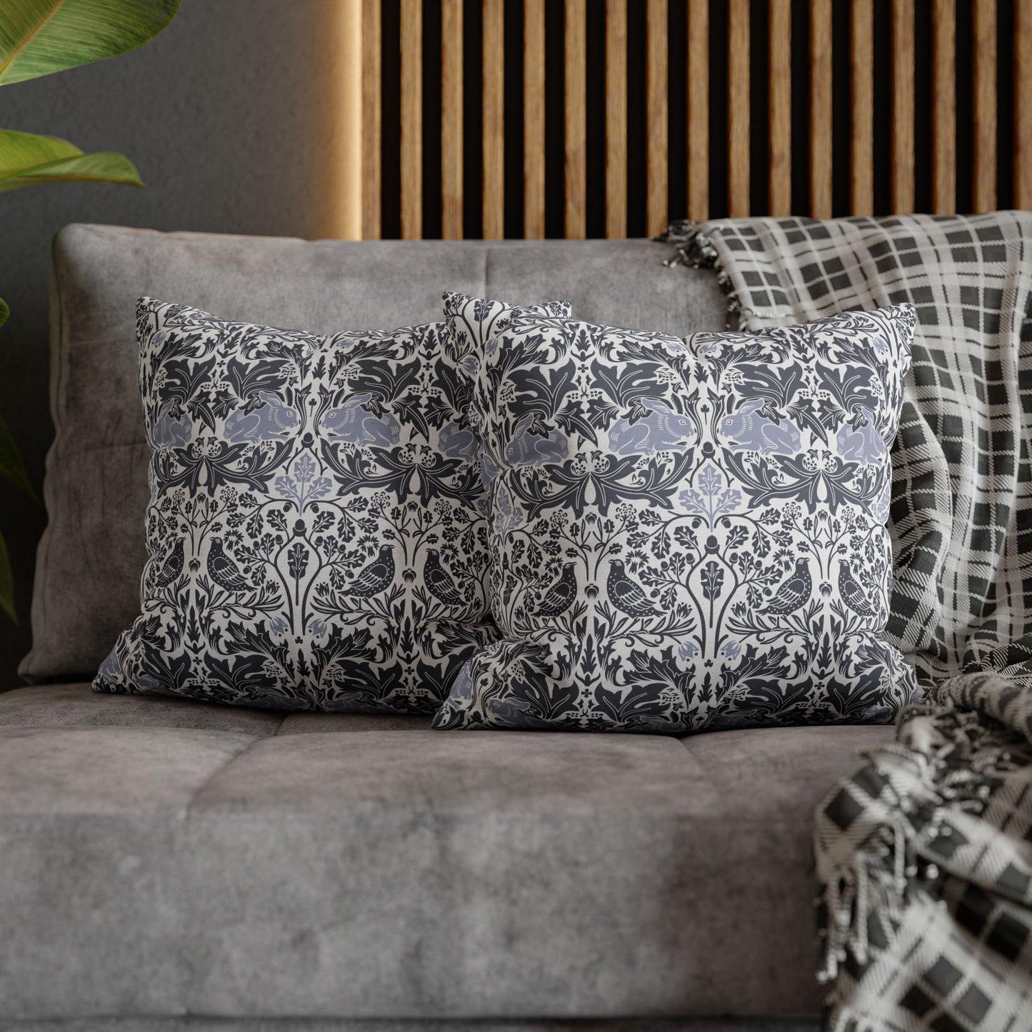 Decorative pillows on a gray sofa with a wooden headboard in the background