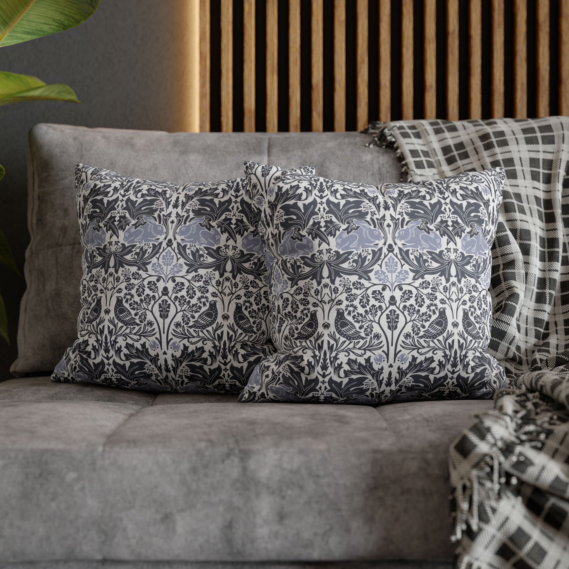 Decorative pillows on a gray sofa with a wooden headboard in the background