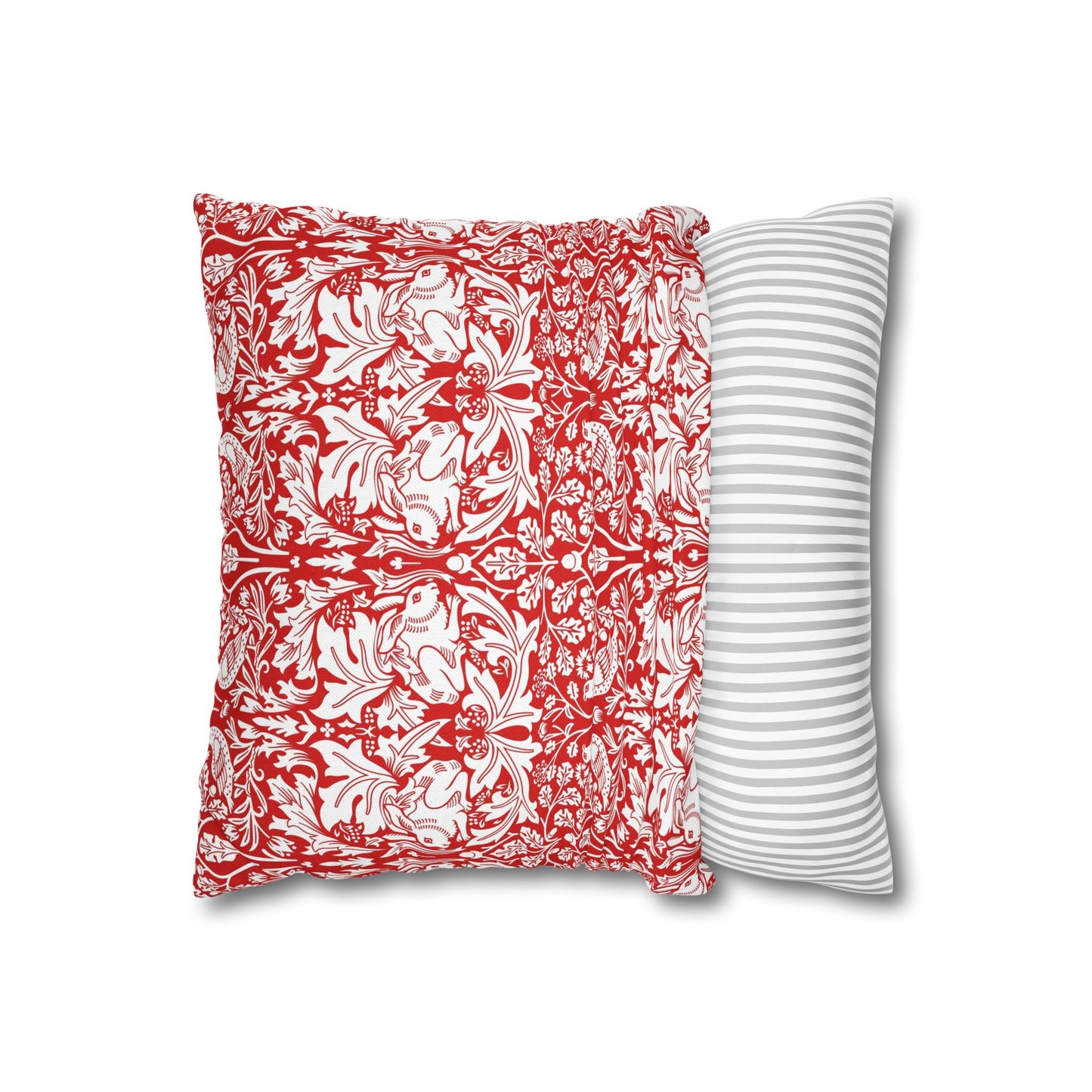 Two pillows, one with red floral pattern and the other with white stripes, on a white background.