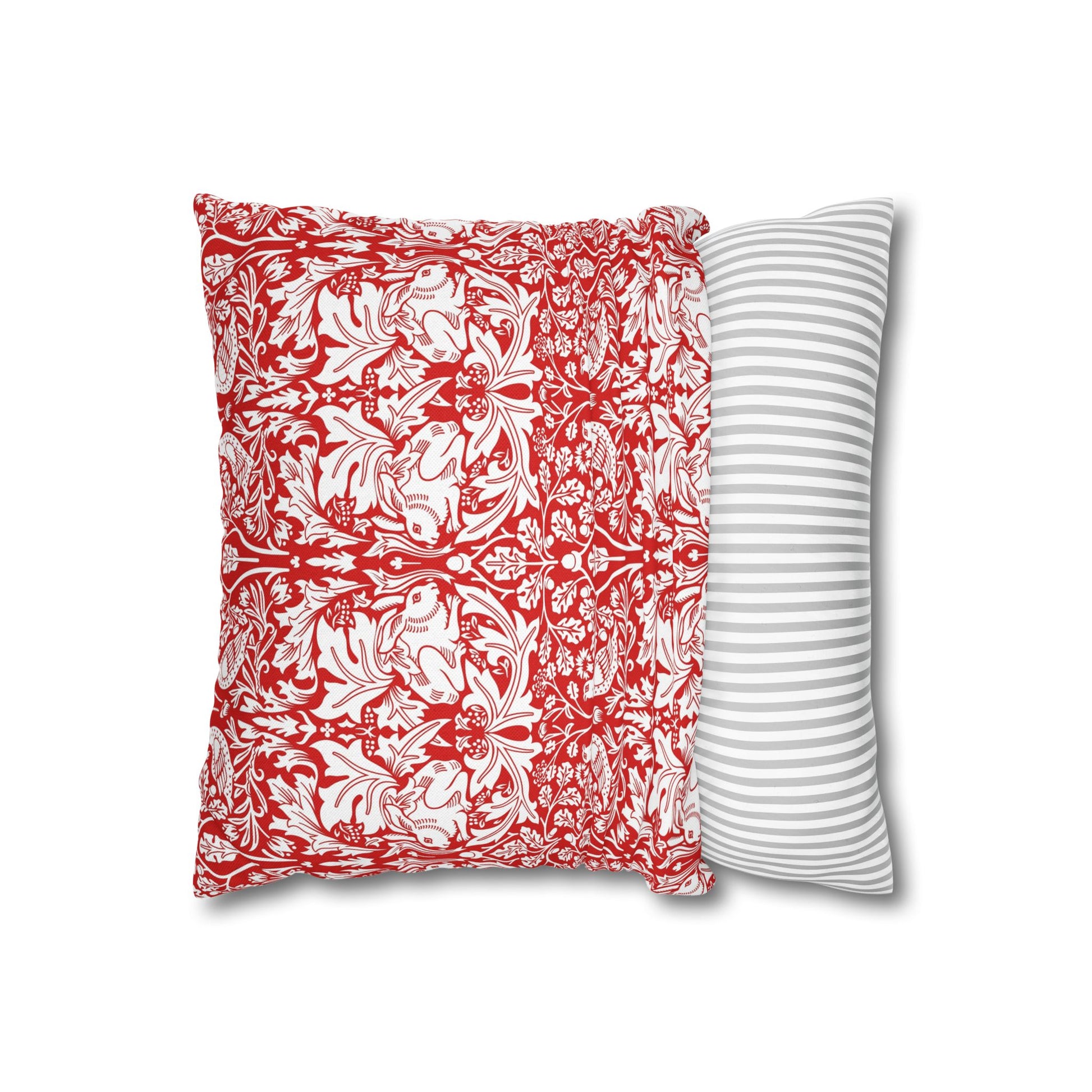 Two pillows, one with red floral pattern and the other with white stripes, on a white background.